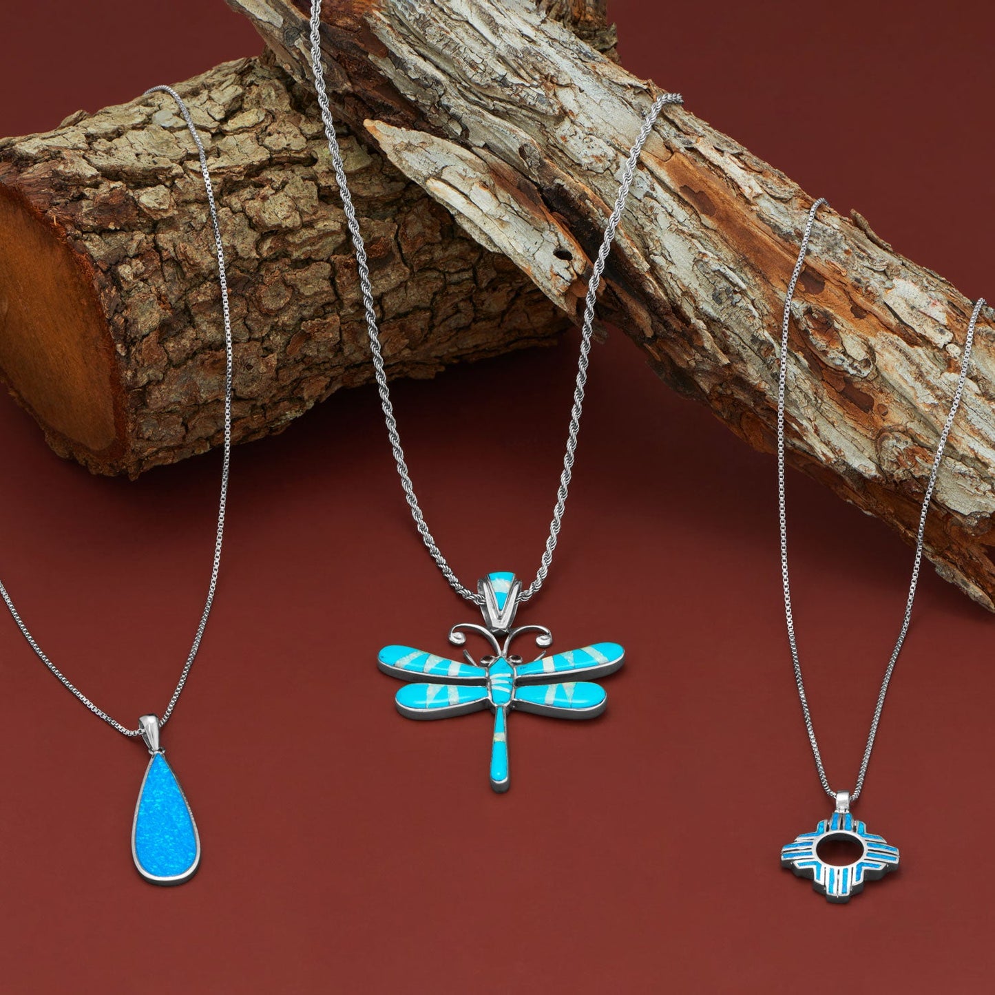 Rhodium Plated Synthetic Blue Opal Elongated Pear Pendant