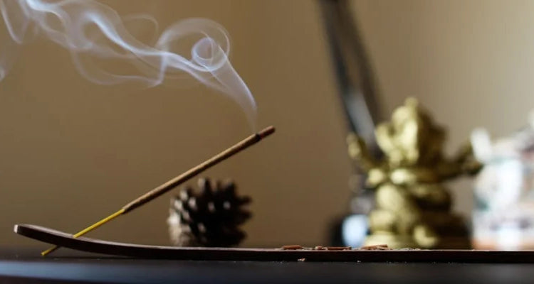 Incense stick with smoke on a blurred background