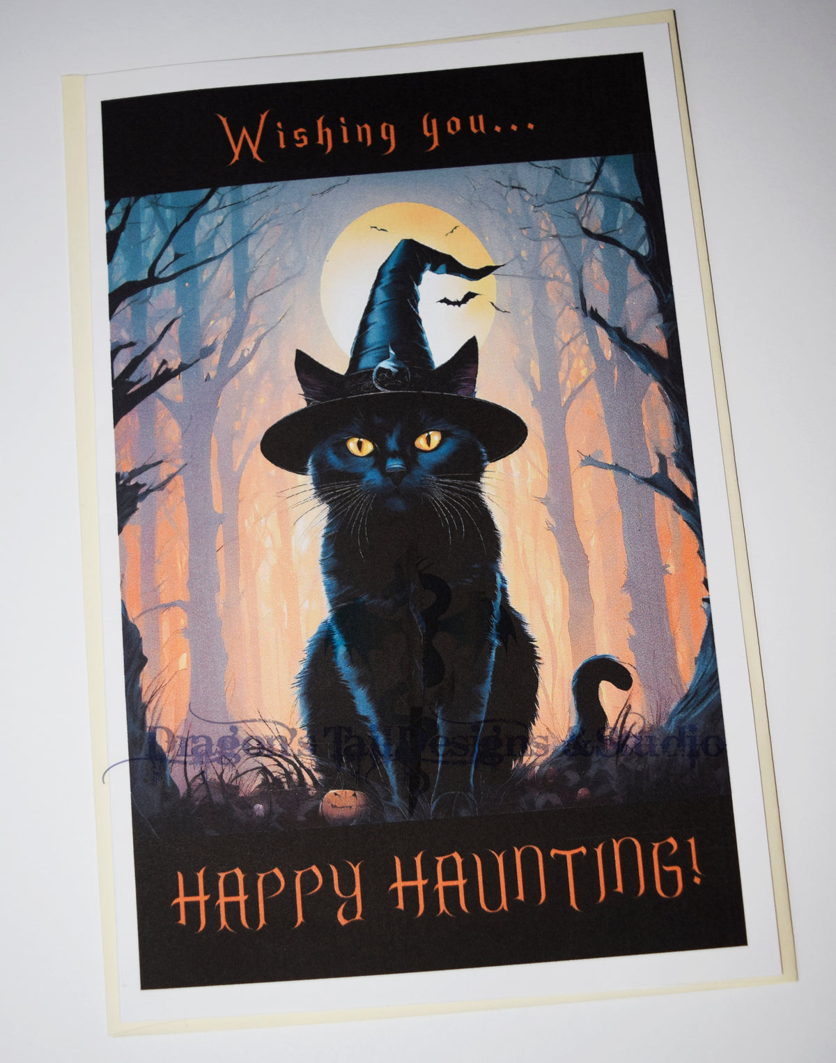 A black cat wishing you Happy Hauntings, Handcrafted All Occasion Greeting Card, blank inside.