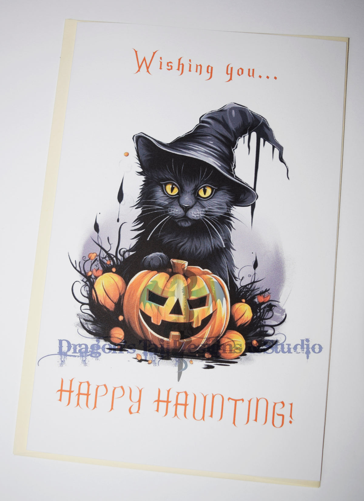 A black cat wishing you Happy Hauntings, Handcrafted All Occasion Greeting Card, blank inside.