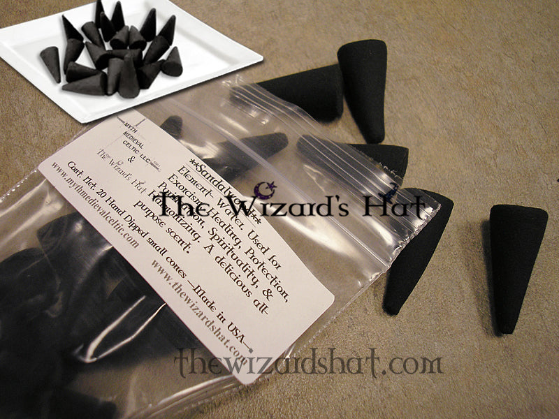 Small charcoal incense  on a beige surface with 'The Wizard's Hat' packaging.